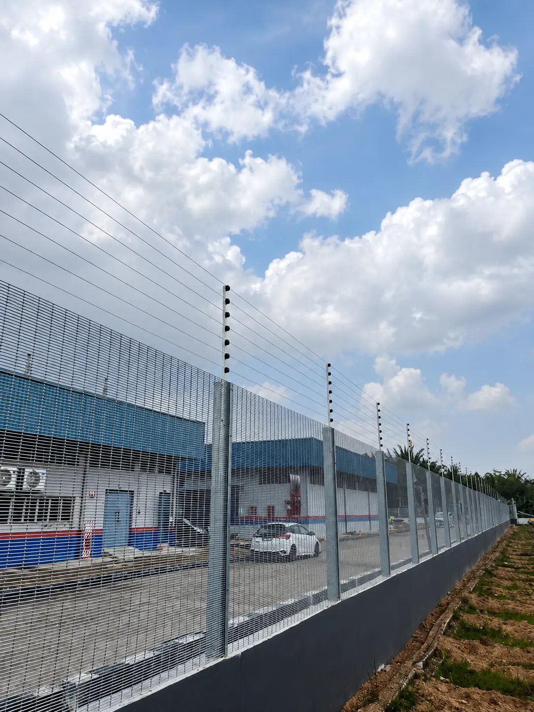 High-security electric fence protecting an industrial facility perimeter