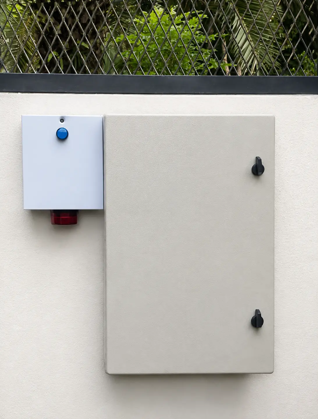 Outdoor electric fence control enclosure on a clean boundary wall